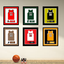 Load image into Gallery viewer, a group of framed sports jerseys on a wall